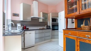 A modern kitchen with stainless steel appliances, a built-in oven, and a microwave.