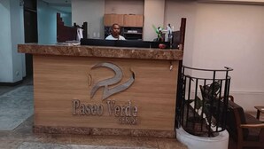 A reception desk with a logo and the name 'Paseo Verde at Real'. - Paseo Verde Condominium (Las Pinas)