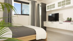 A modern bedroom with a bed, a TV, and a white cabinet. - Dèpendance - Lequile - Alfa Country House (Lequile)