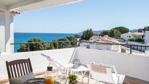 A balcony with a table set for two, overlooking a coastal view. - Appartement DE 1 Chambre (Llançà)