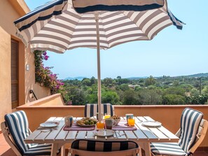 Enjoy a meal on the terrace with a view of the lush landscape.
