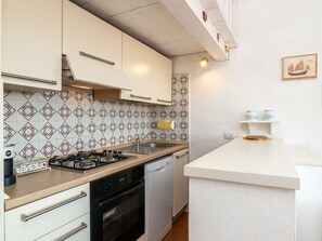 Enjoy cooking in this well-equipped kitchen with a gas stove, oven, and dishwasher.