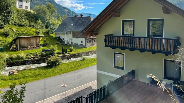 Uma casa de dois andares com uma varanda, um pequeno galinheiro e um rio ao fundo.