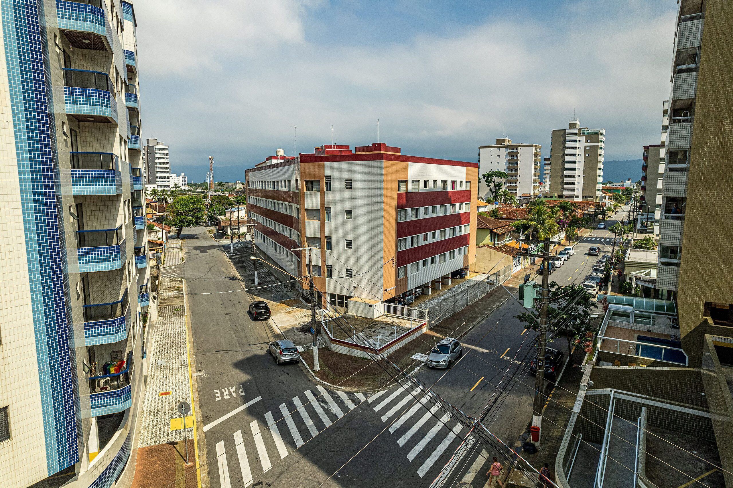 A multi-story building with a central courtyard, surrounded by other buildings.