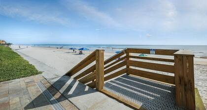 Direct oceanfront condo with a private balcony, heated beachfront pool, and beach access