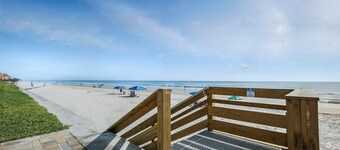Direct oceanfront condo with a private balcony, heated beachfront pool, and beach access