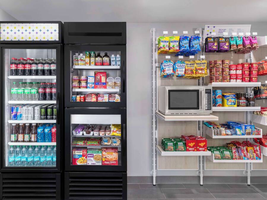 A refrigerated display with various beverages and snacks.