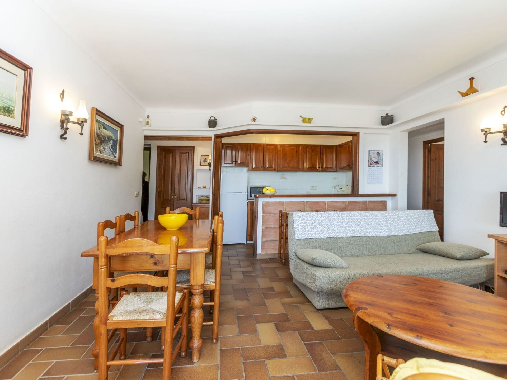 A compact living space with a dining area, kitchenette, and seating area.