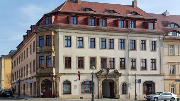 A historic building with a red-tiled roof, multiple windows, and a central entrance with an archway. - Beautiful apartment for 6 people with WIFI, TV, patio and pets allowed (Zittau)