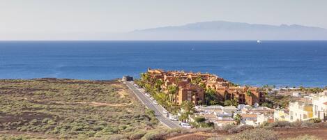 A coastal town with a historic fort, a main road, and a view of the sea.