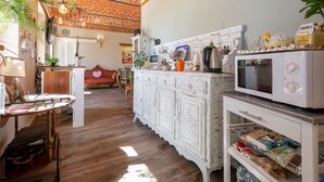 A kitchen with a rustic brick ceiling, white cabinetry, and a microwave. - Stunning  villa for 10 people with A/C, private pool, WIFI and patio (San Damiano D'asti)
