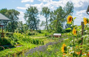 Escape to a serene garden oasis, surrounded by vibrant flowers and lush greenery.