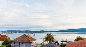 A coastal town with a marina, boats, and a clear view of the sea.