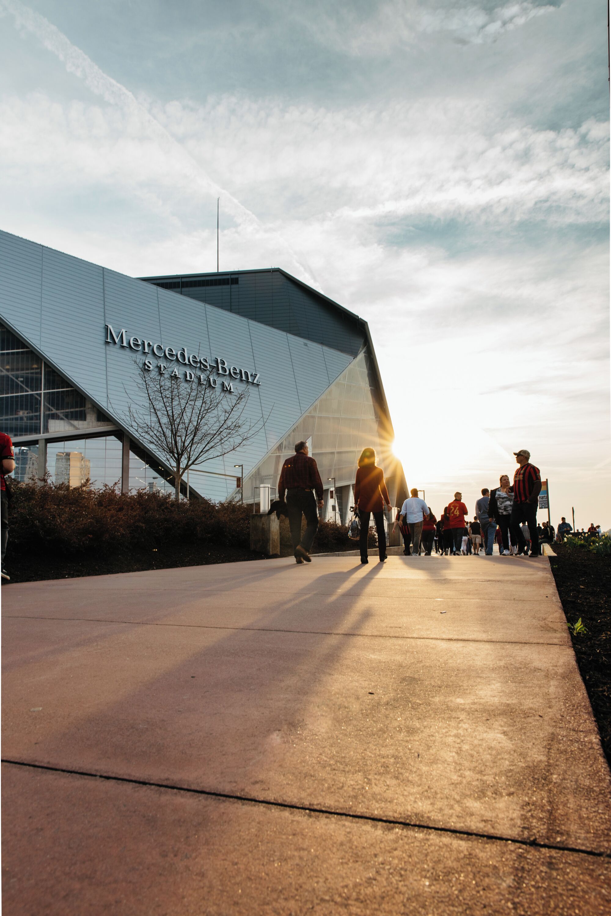A modern building with the text "Mercedes-Benz Stadium" on its facade.