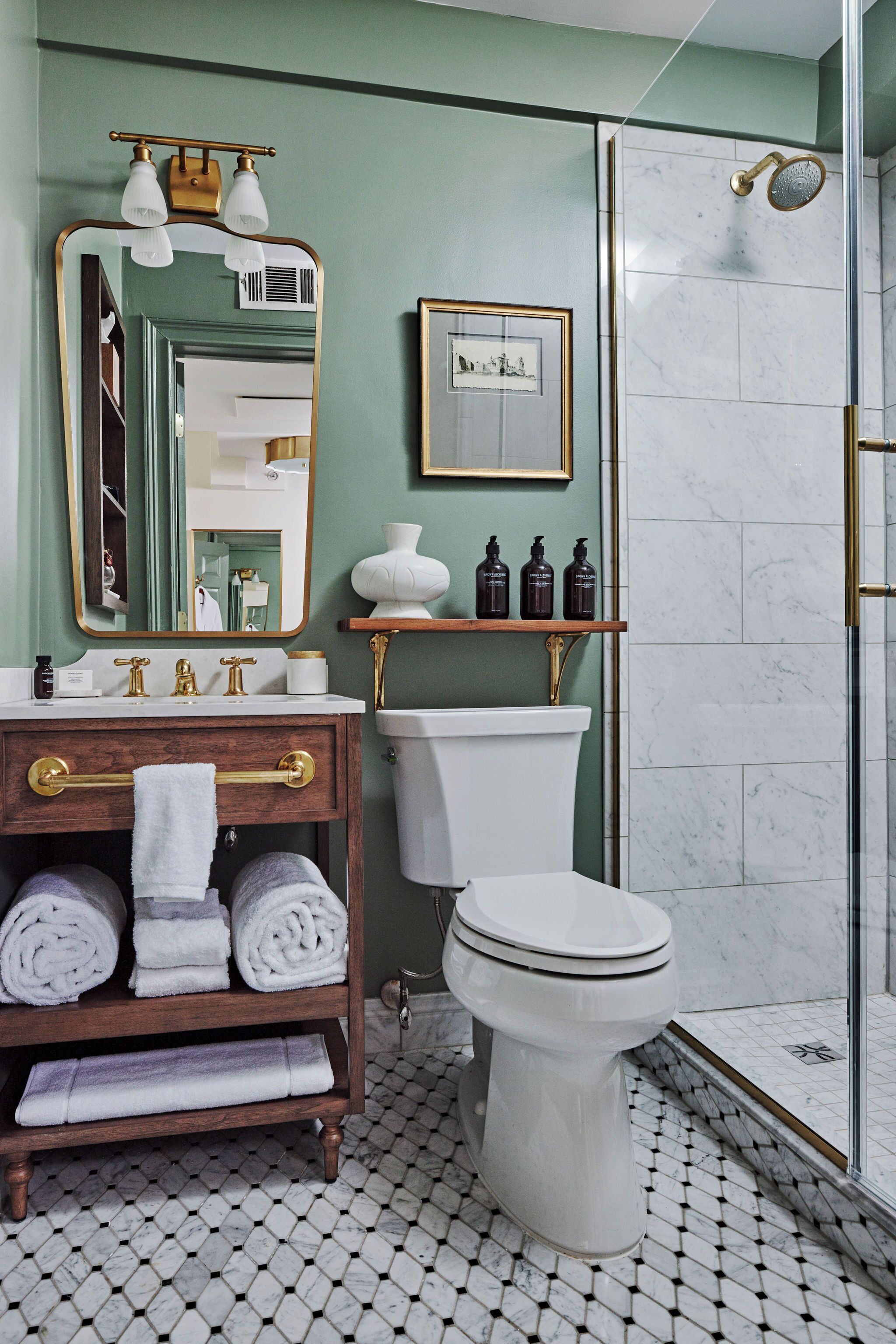 A bathroom with a toilet, sink, and shower.