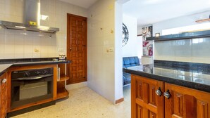 A kitchen with wooden cabinets, a stove, and a countertop. - Gorgeous home in Orba (Orba)