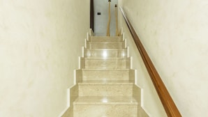 A marble staircase with a wooden handrail leading to a door at the top. - Stunning  villa for 6 guests with WIFI, A/C, TV and balcony (Partinico)