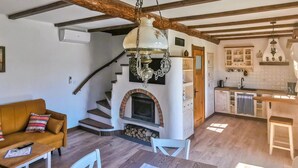 A rustic interior with a fireplace, wooden staircase, and a kitchen area. - Beautiful home in Kopalino with WiFi (Kopalino)