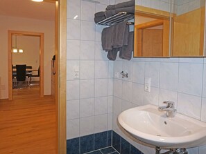 Bathroom features a sink, mirror, and towel rack.
