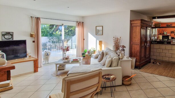 A living room with a sofa, a TV, a dining table, and a kitchen area. - Beautiful home in Vias (Vias)