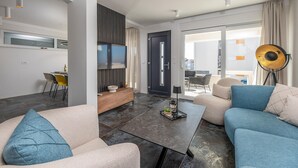 A modern living room with a sofa, a coffee table, and a TV. - Nice home in Novalja with sauna (Novalja)