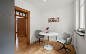 Enjoy meals in this stylish dining area with a round table and two comfortable chairs.