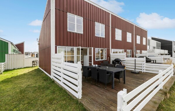 Enjoy al fresco dining on the covered deck with a barbecue grill and dining table.