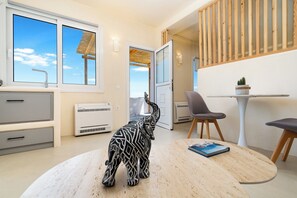 Junior Suite | Living area | 32-inch flat-screen TV with satellite channels, TV - Eolithos Suites (Santorini)