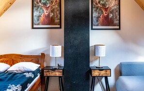 Cozy bedroom with a wooden bed, bedside tables, and rustic charm.