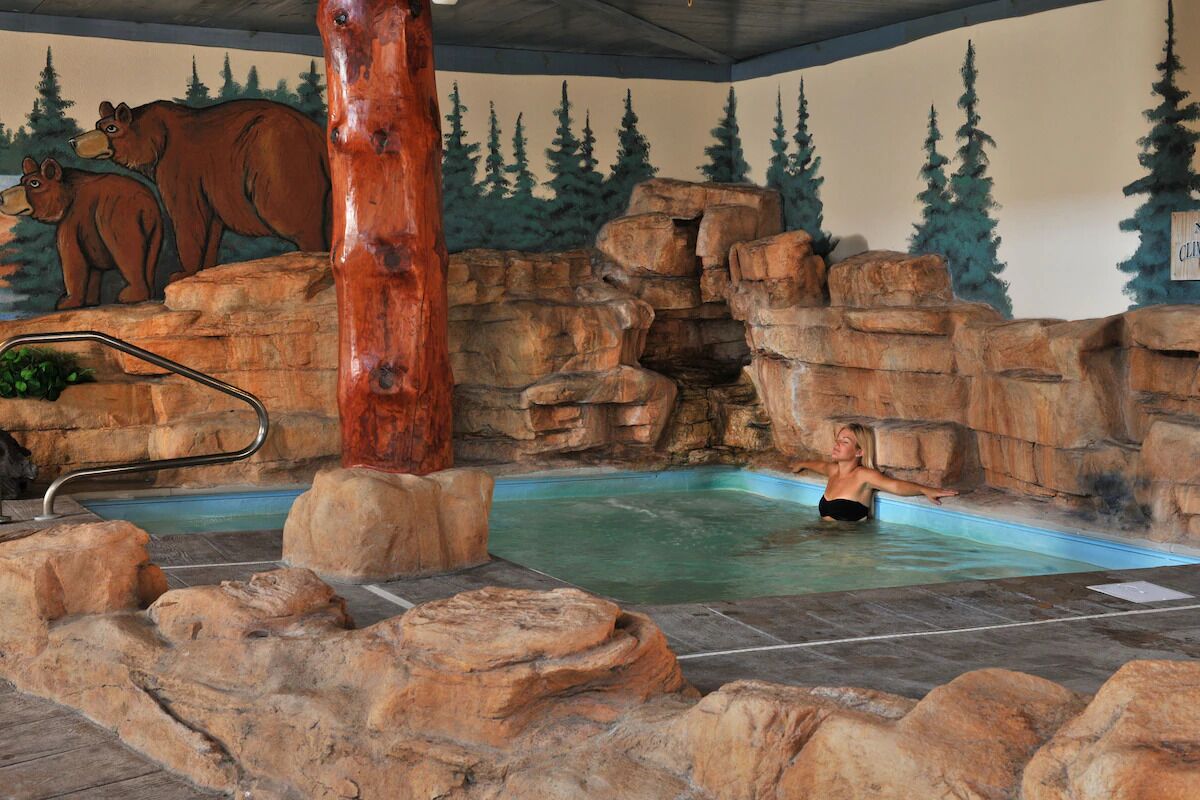 Unwind in the grotto hot tub beneath mountain murals.