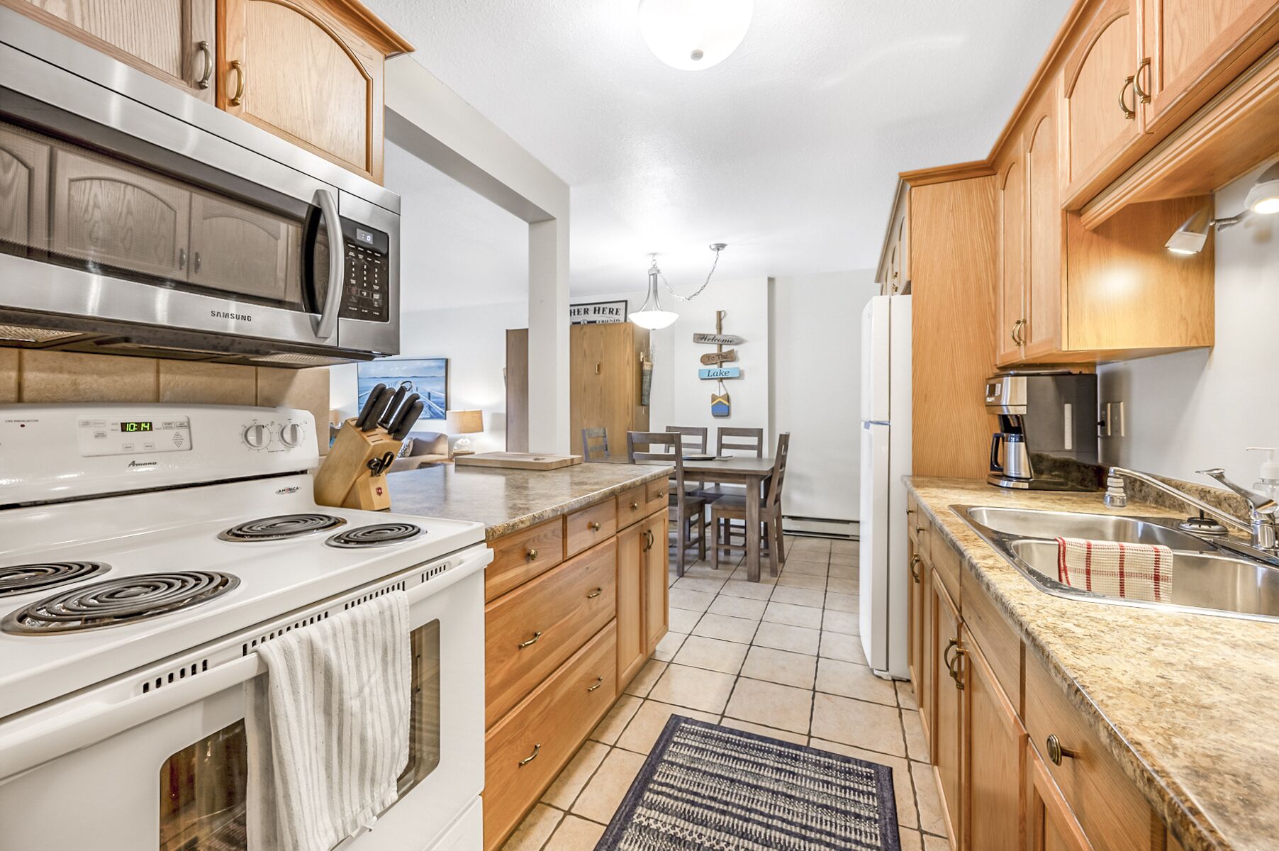 Una cocina moderna con electrodomésticos de acero inoxidable, armarios de madera y una isla central.