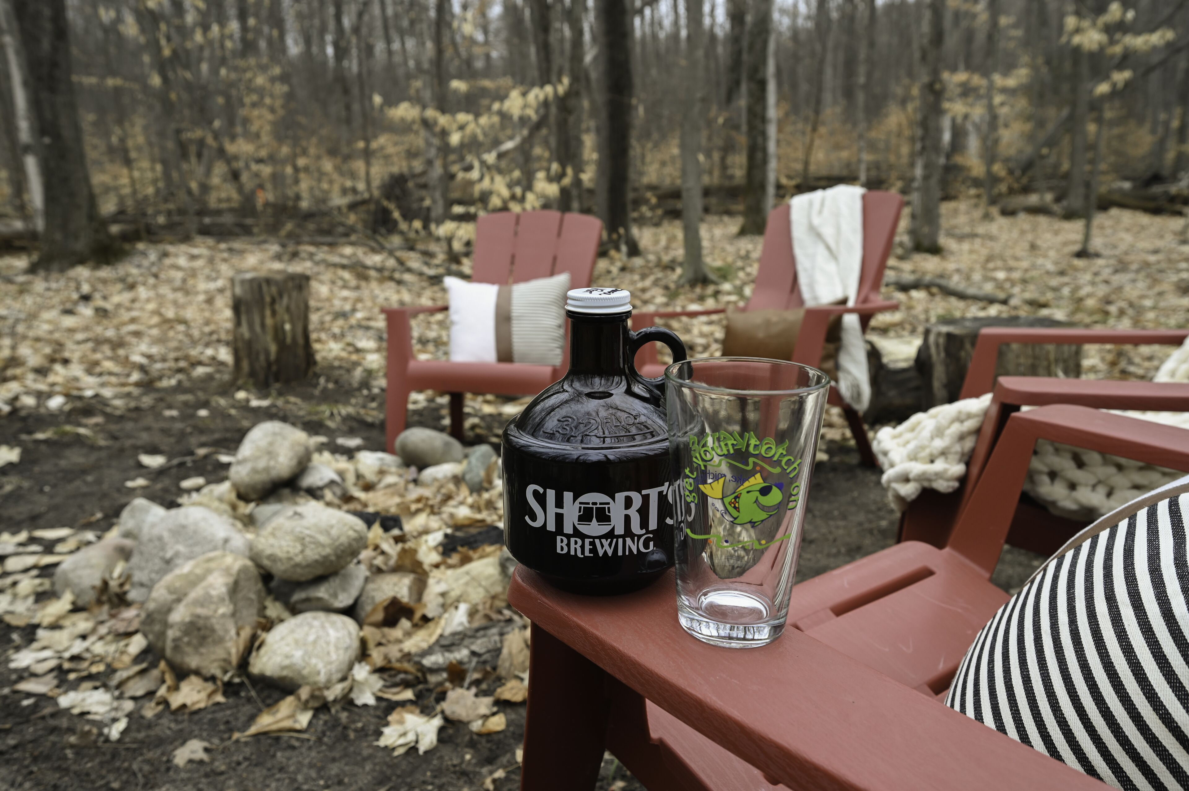 A table with a bottle labeled "SHORT'S BREWING" and a glass with a green design.