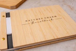 A wooden cutting board with engraved text. - Natchez Charm | 1/1 | Full Kitchen, King Bed, 2 Blocks from Mississippi River (Natchez)