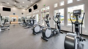 A gym with treadmills, stationary bikes, and weight machines.