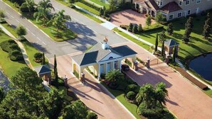 A large, single-story house with a covered porch, a driveway, and a well-maintained lawn.