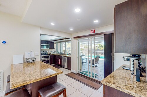 Ideally located home with enclosed pool, grill, W/D, & AC - snowbird-friendly