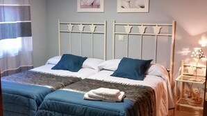 A double bed with a white headboard, two pillows, and a blue blanket. - Country House 'El Rincón De Gredos' with Mountain Views by the River – Cozy Retreat (Navaluenga)