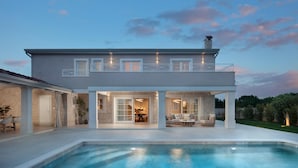 A modern two-story house with a large swimming pool, a covered patio, and a stone facade. - Villa Gabriel Residence (Zminj)