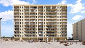 A multi-story hotel with balconies, located on a beach. - Boardwalk 584 (Gulf Shores)