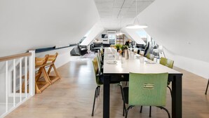 A modern office space with a long table, chairs, and a staircase. - "Nafne" - 1.2km from the sea by Interhome (Hvide Sande)
