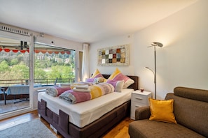 Ein Schlafzimmer mit einem Bett, einem Nachttisch und einem Sofa.