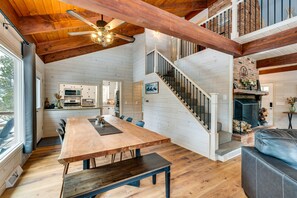 Enjoy communal dining and cozy evenings by the fireplace in this open-plan living space.