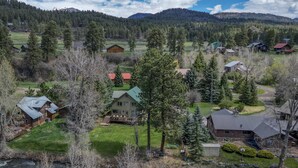 A residential area with houses, a river, and a mountainous backdrop. - Riverfront Fire Pit, Gas Stove, Near Skiing, Hot Springs, & Hiking Adventures! (Pagosa Springs)
