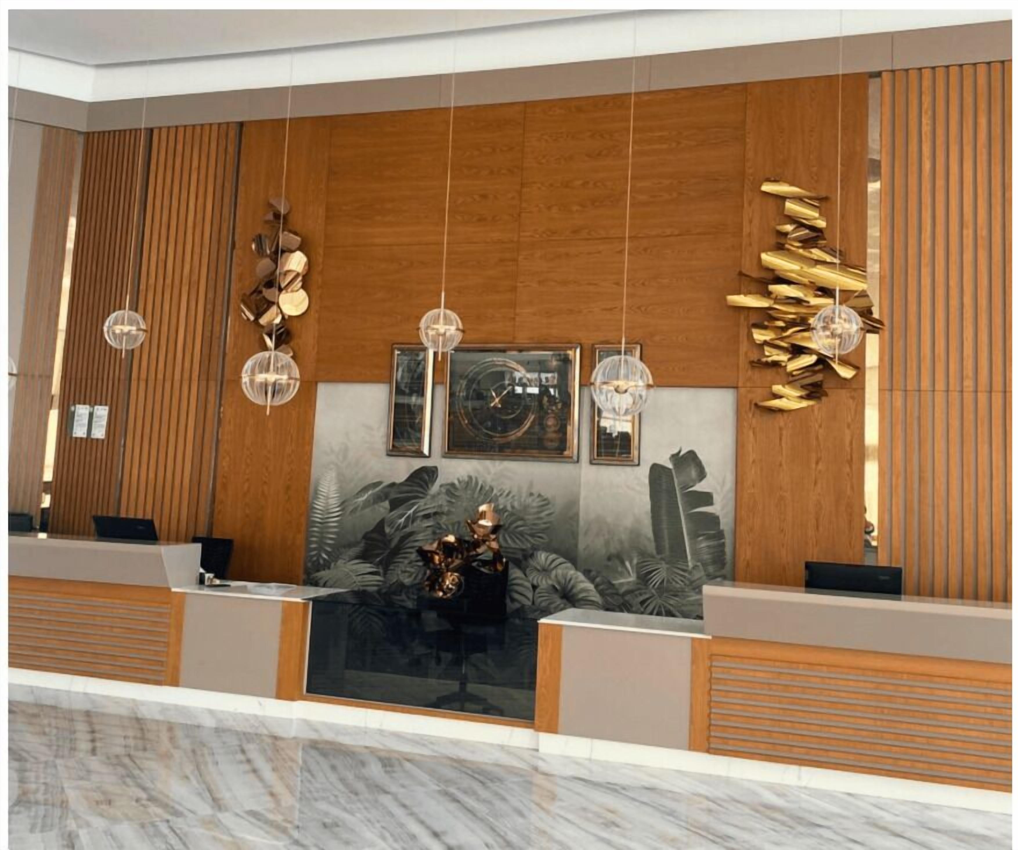 A reception area with a wooden panel wall, a large abstract art piece, and a reception desk.