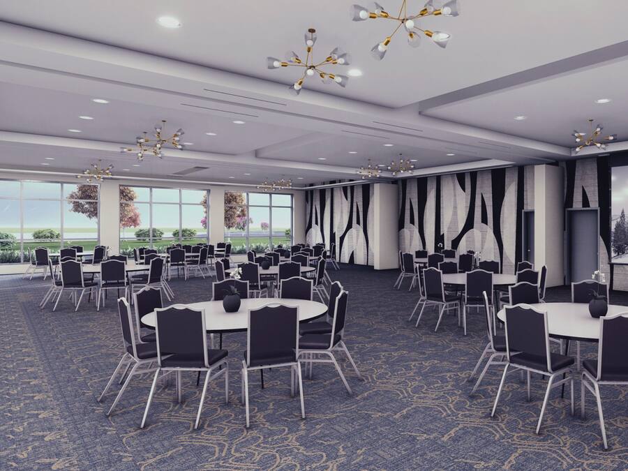 A conference room with round tables and chairs, large windows, and decorative wall panels.
