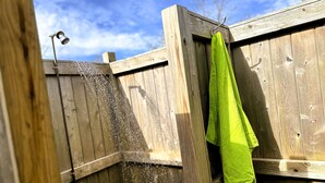 Een houten hek met een groene handdoek aan een haak.