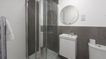 Shower, hair dryer, towels, shampoo
