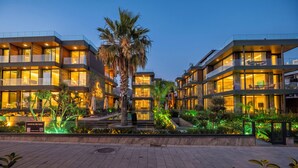 Un hôtel moderne à plusieurs étages, doté d’une terrasse et d’une cour bien éclairée.