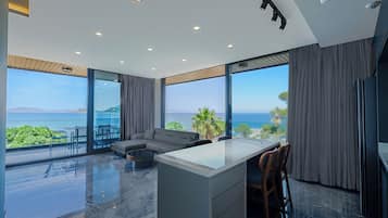 Panoramic Suite, 2 Bedrooms, Sea View, Beachfront | Living area | 105-inch Smart TV with satellite channels, Netflix, streaming services