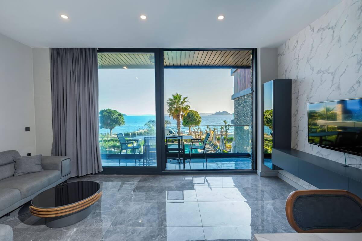 Premium Suite, 2 Bedrooms, Beachfront | Living area | 105-inch Smart TV with satellite channels, Netflix, streaming services